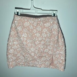 Size 6, pink, floral patterned skirt. Small slit on left leg and zipper in back